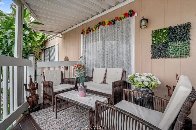 a view of a deck with furniture and garden