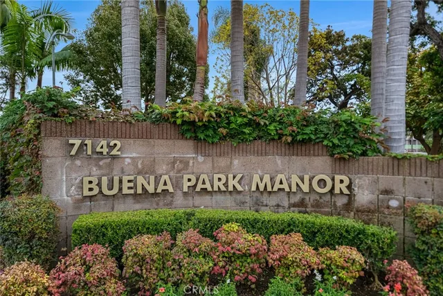 a sign that is in front of flowers