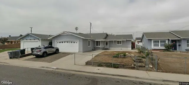 a view of a house with a car parked in front of it