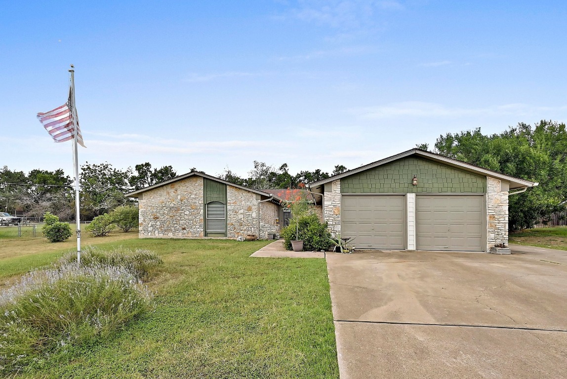 a view of a house with a yard and garage