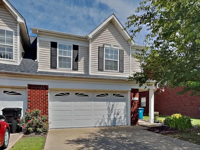 a view of a house with a yard and garage