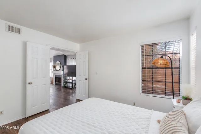 a bedroom with a bed and a large window