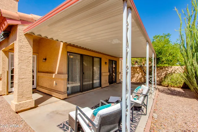 a view of a patio with table and chairs and potted plants