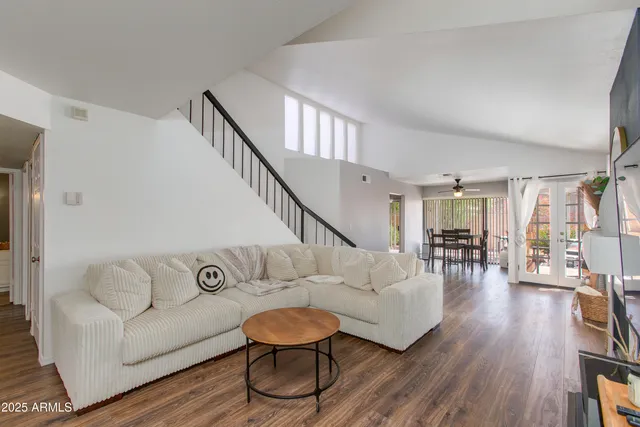a living room with furniture and wooden floor