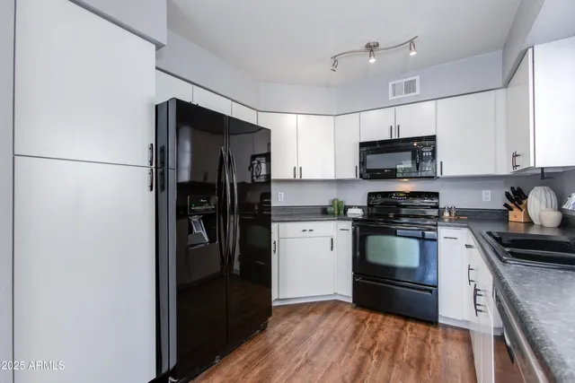a kitchen with stainless steel appliances a refrigerator stove and microwave