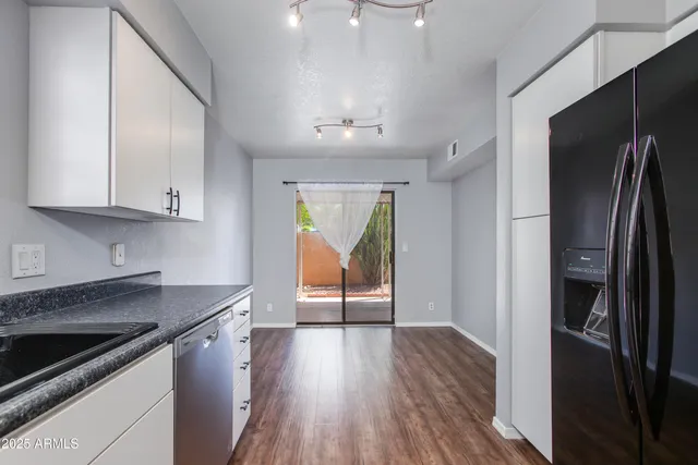 a kitchen with a refrigerator and a sink
