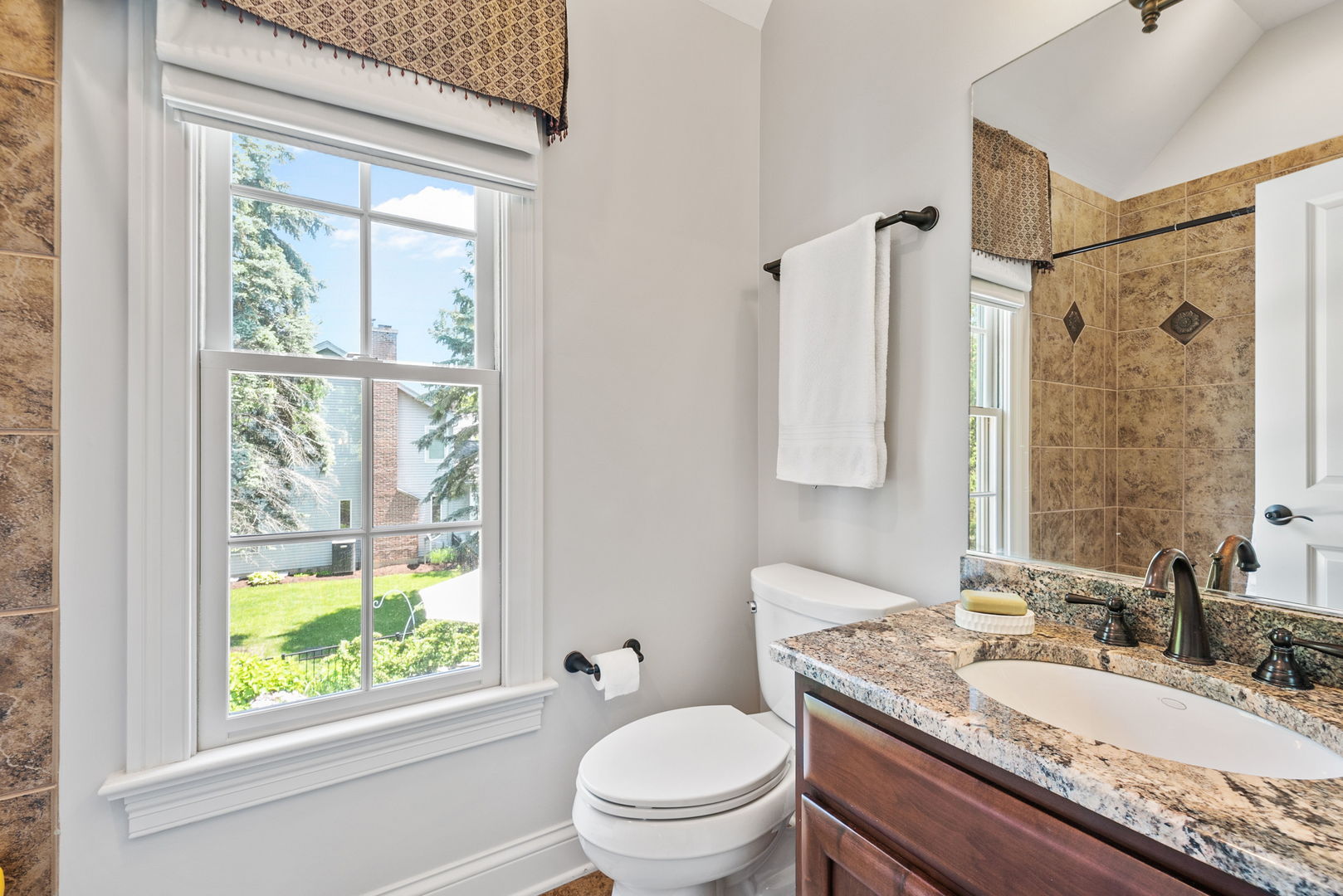1209 Dunstan Road Geneva, IL 60134 - Photo 19 of 27 a bathroom with a granite countertop sink toilet and shower