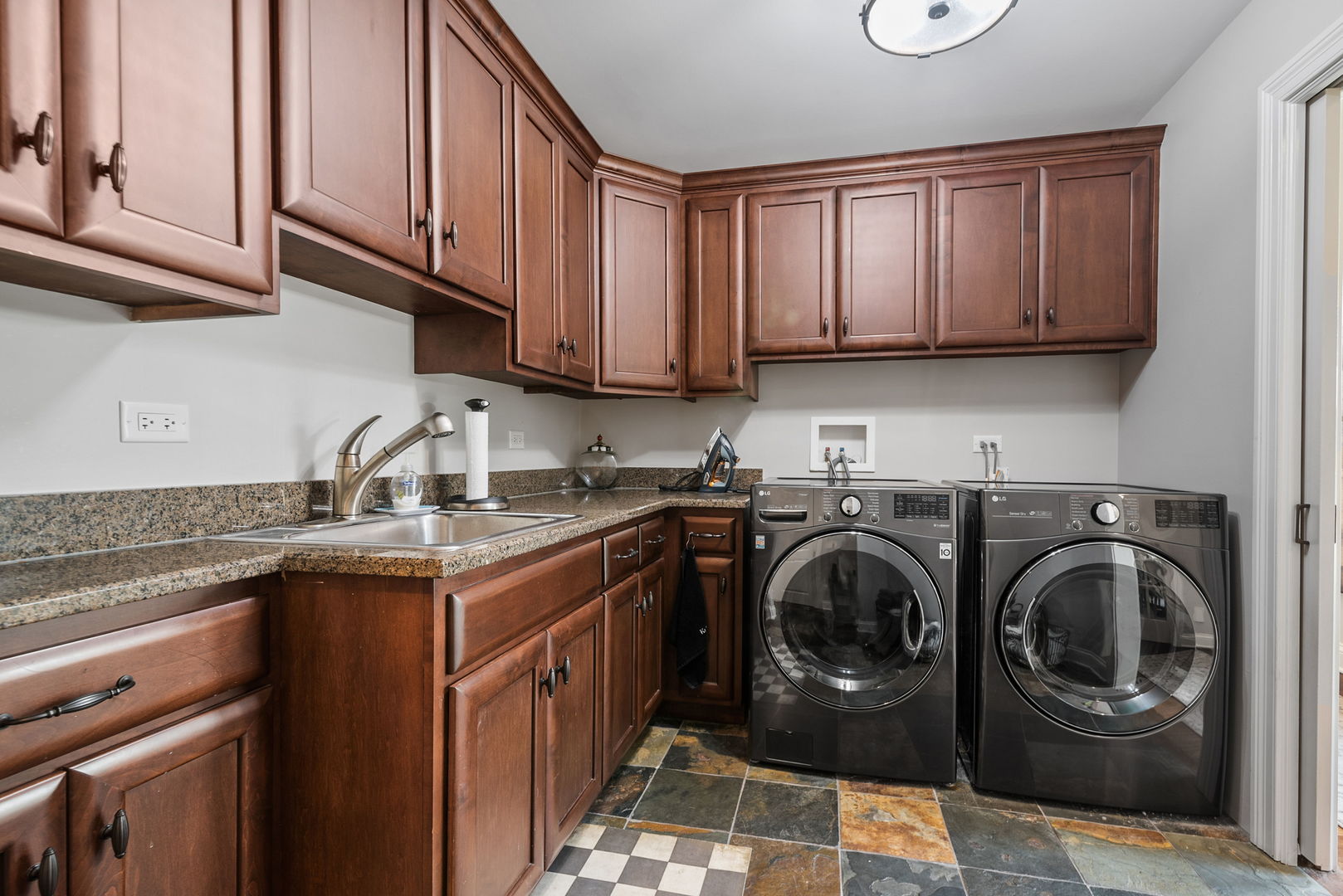 1209 Dunstan Road Geneva, IL 60134 - Photo 10 of 27 a utility room with stainless steel appliances granite countertop a sink a washer and dryer