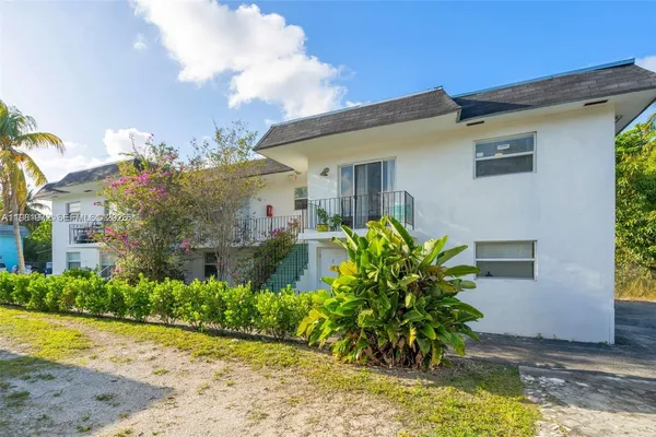 a view of kitchen with refrigerator and window