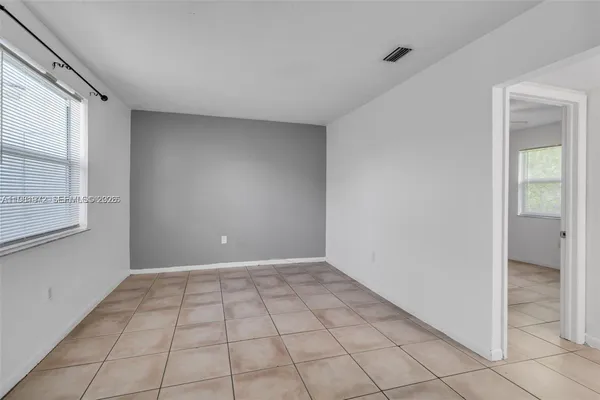 a kitchen with cabinets a refrigerator and a sink