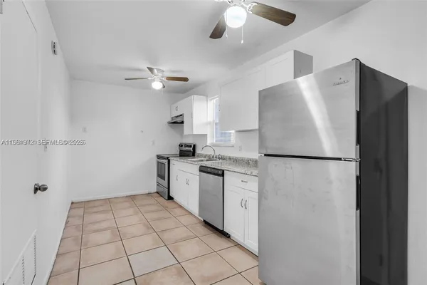 a kitchen with cabinets stainless steel appliances and a sink