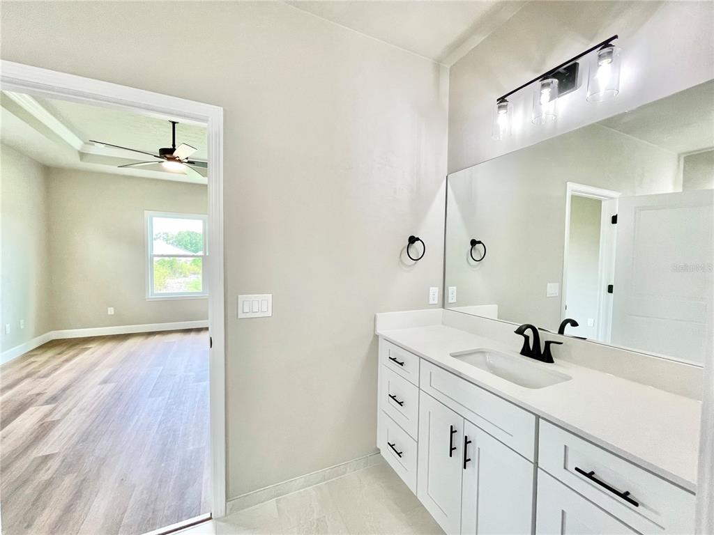 1021 Southwest 67th Street Gainesville, FL 32607 - Photo 18 of 53 a bathroom with a sink and a mirror