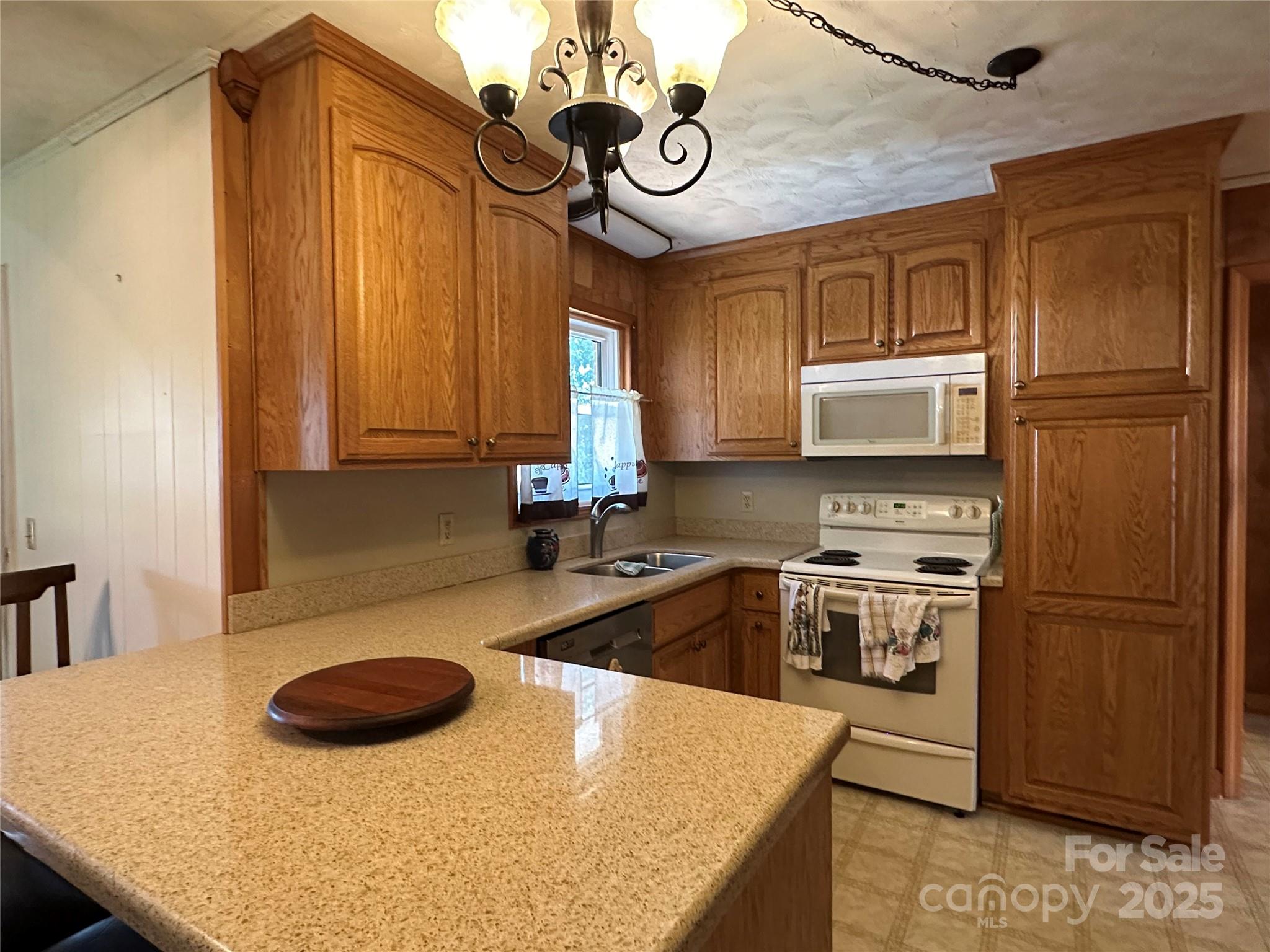 625 Teddar Road Mount Gilead, NC 27306 - Photo 13 of 25 a kitchen with stainless steel appliances granite countertop a sink a stove a microwave a refrigerator and cabinets