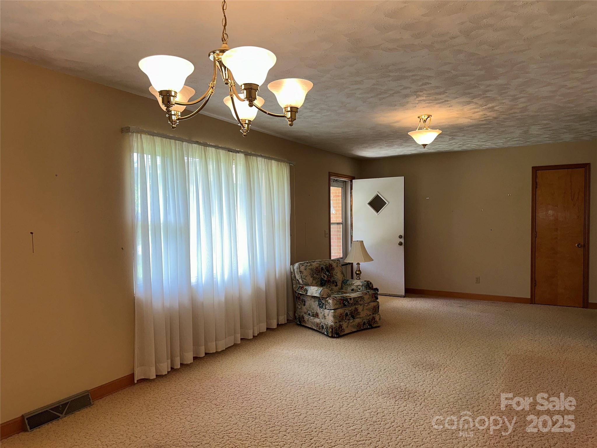 625 Teddar Road Mount Gilead, NC 27306 - Photo 9 of 25 a view of a livingroom with a chandelier furniture and windows