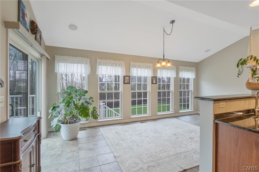8294 Luchsinger Lane Lysander, NY 13027 - Photo 11 of 47 Bright and airy morning room w/vaulted ceiling and