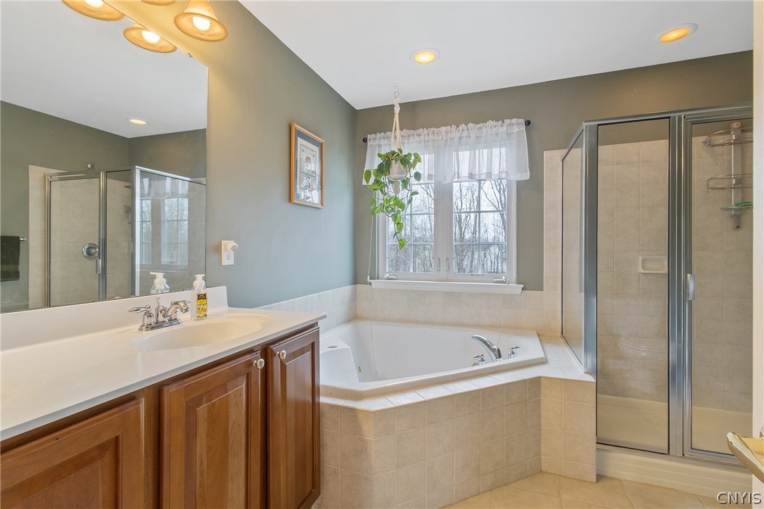 8294 Luchsinger Lane Lysander, NY 13027 - Photo 28 of 47 Primary bath has jacuzzi tub, double vanity, ceram