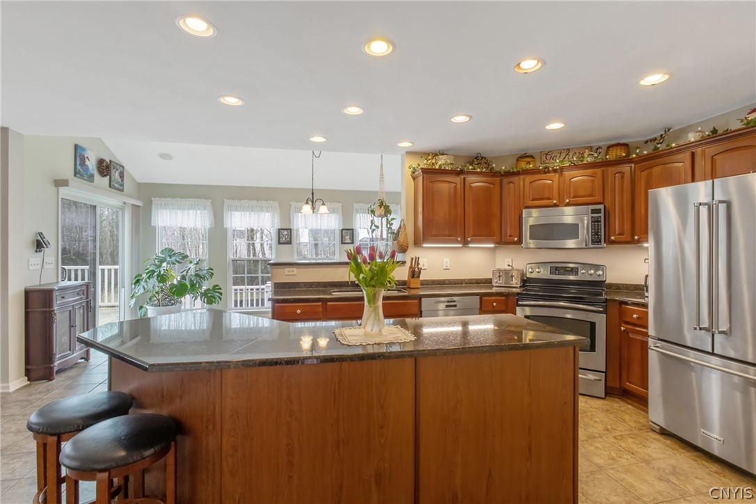 8294 Luchsinger Lane Lysander, NY 13027 - Photo 8 of 47 Large 8' island with granite counter tops.