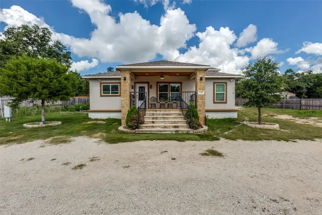 a front view of a house with garden