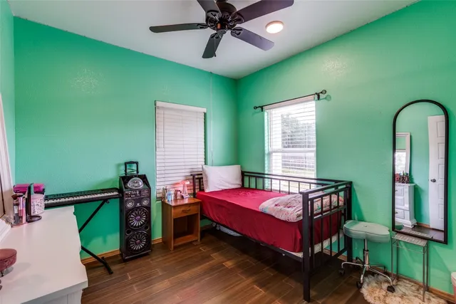 a bathroom with a granite countertop toilet sink and mirror