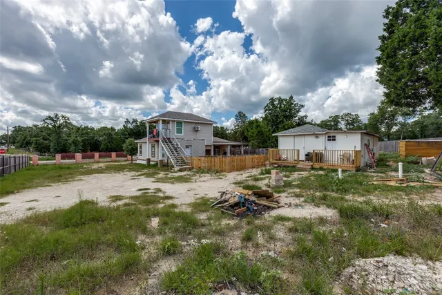 a bedroom with a bed a flat screen tv and a window