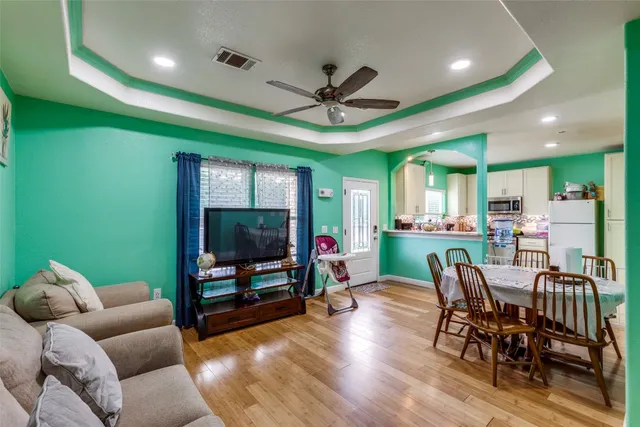 a living room with furniture a window and a flat screen tv