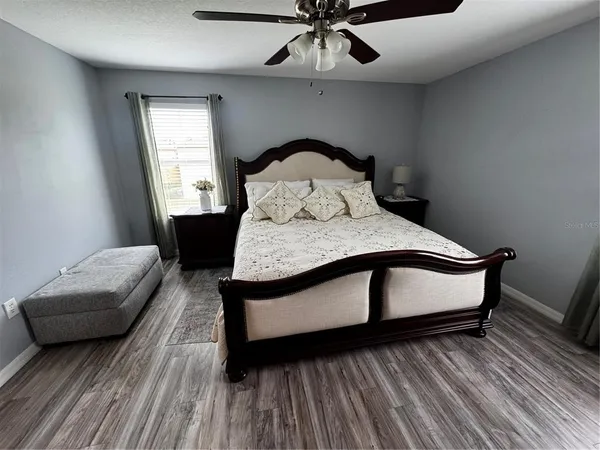 a bedroom with a bed and a window