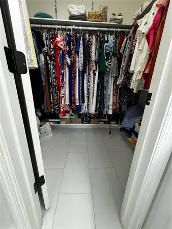 a view of walk in closet with clothes