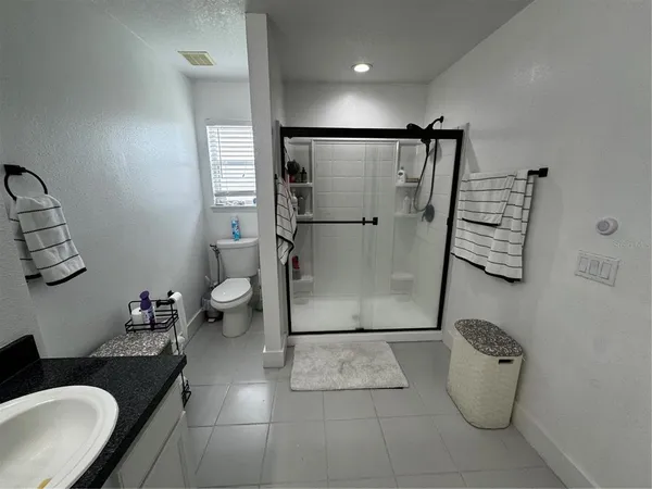 a bathroom with a sink toilet and shower