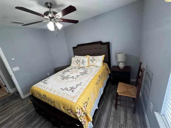 a bed sitting in a bedroom and a chandelier