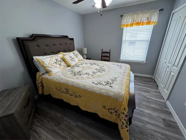 a bed sitting in a bedroom next to a window