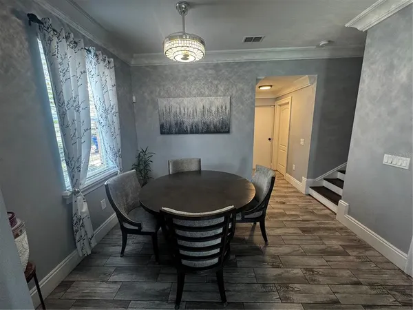 a dining room with furniture and window