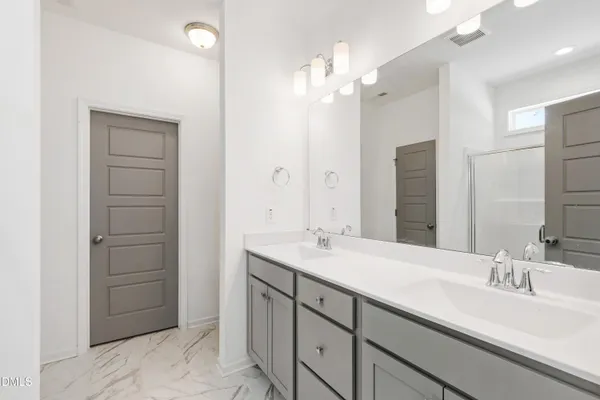 a bathroom with a sink double vanity and a mirror