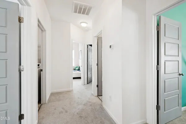 a view of a hallway with a dining area