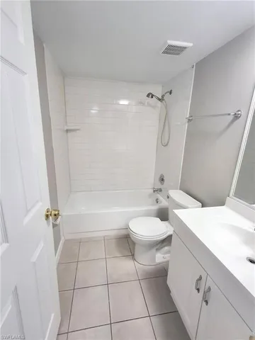 a bathroom with a granite countertop sink toilet a mirror and shower