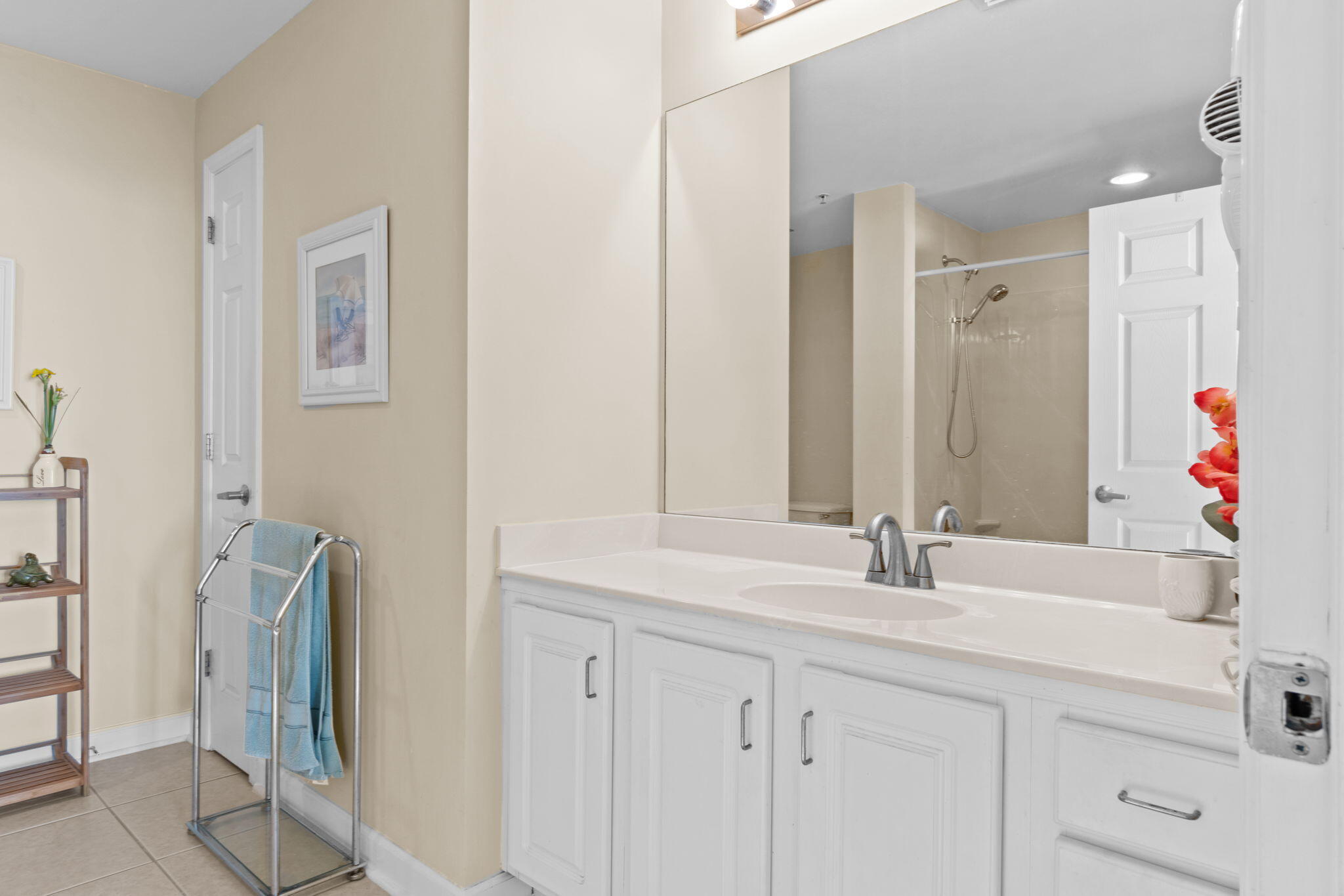 12011 Front Beach Road, Unit 201C Panama City Beach, FL 32407 - Photo 11 of 42 a bathroom with a sink and a mirror
