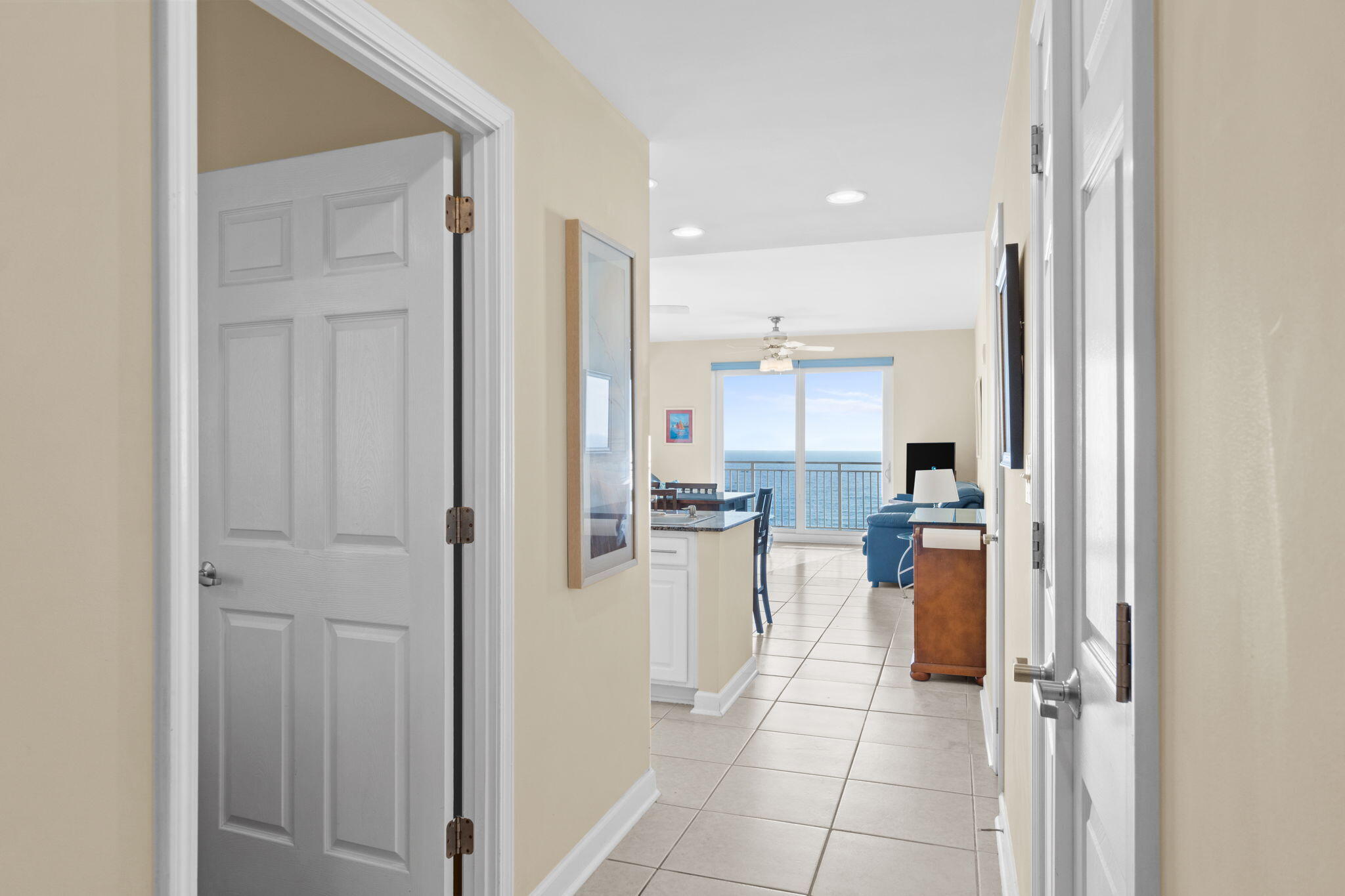 12011 Front Beach Road, Unit 201C Panama City Beach, FL 32407 - Photo 21 of 42 a view of a kitchen with refrigerator and table