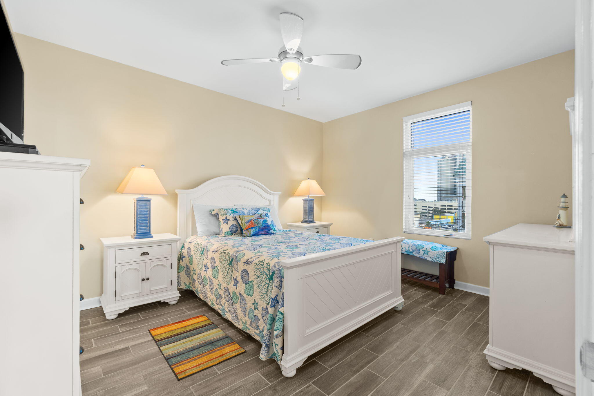 12011 Front Beach Road, Unit 201C Panama City Beach, FL 32407 - Photo 26 of 42 a bedroom with a bed and a chandelier