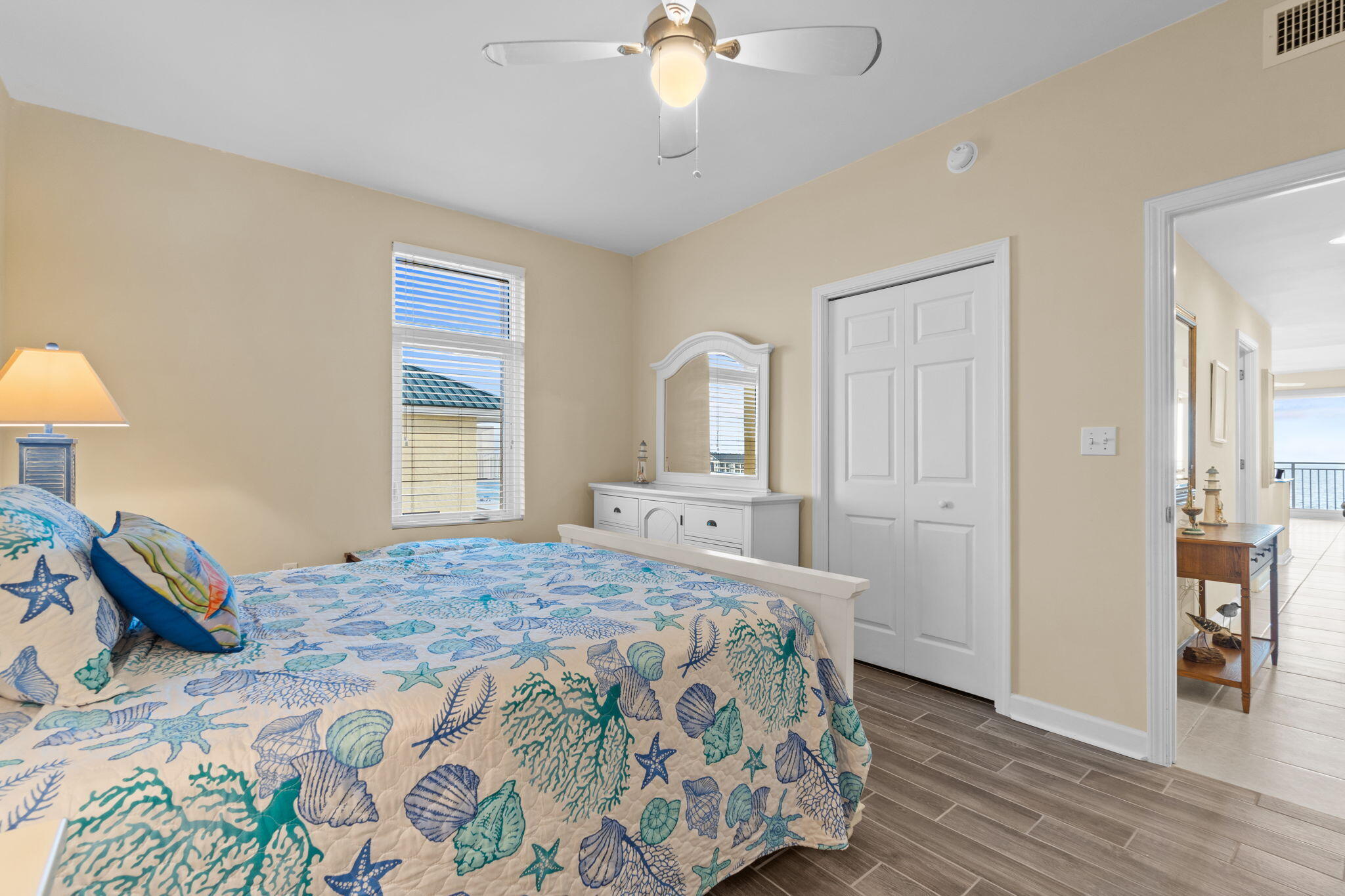 12011 Front Beach Road, Unit 201C Panama City Beach, FL 32407 - Photo 27 of 42 a bedroom with a bed and wooden floor