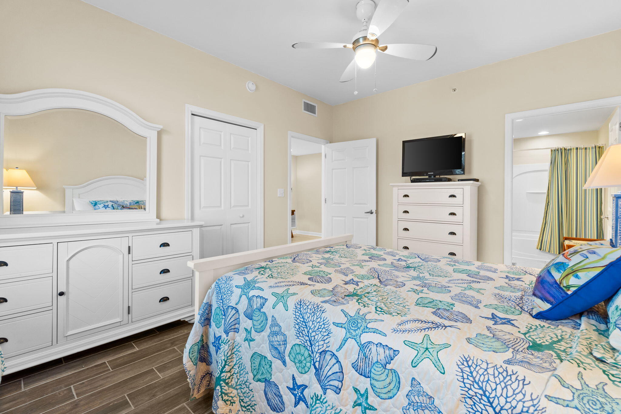 12011 Front Beach Road, Unit 201C Panama City Beach, FL 32407 - Photo 28 of 42 a bedroom with a bed and a flat screen tv