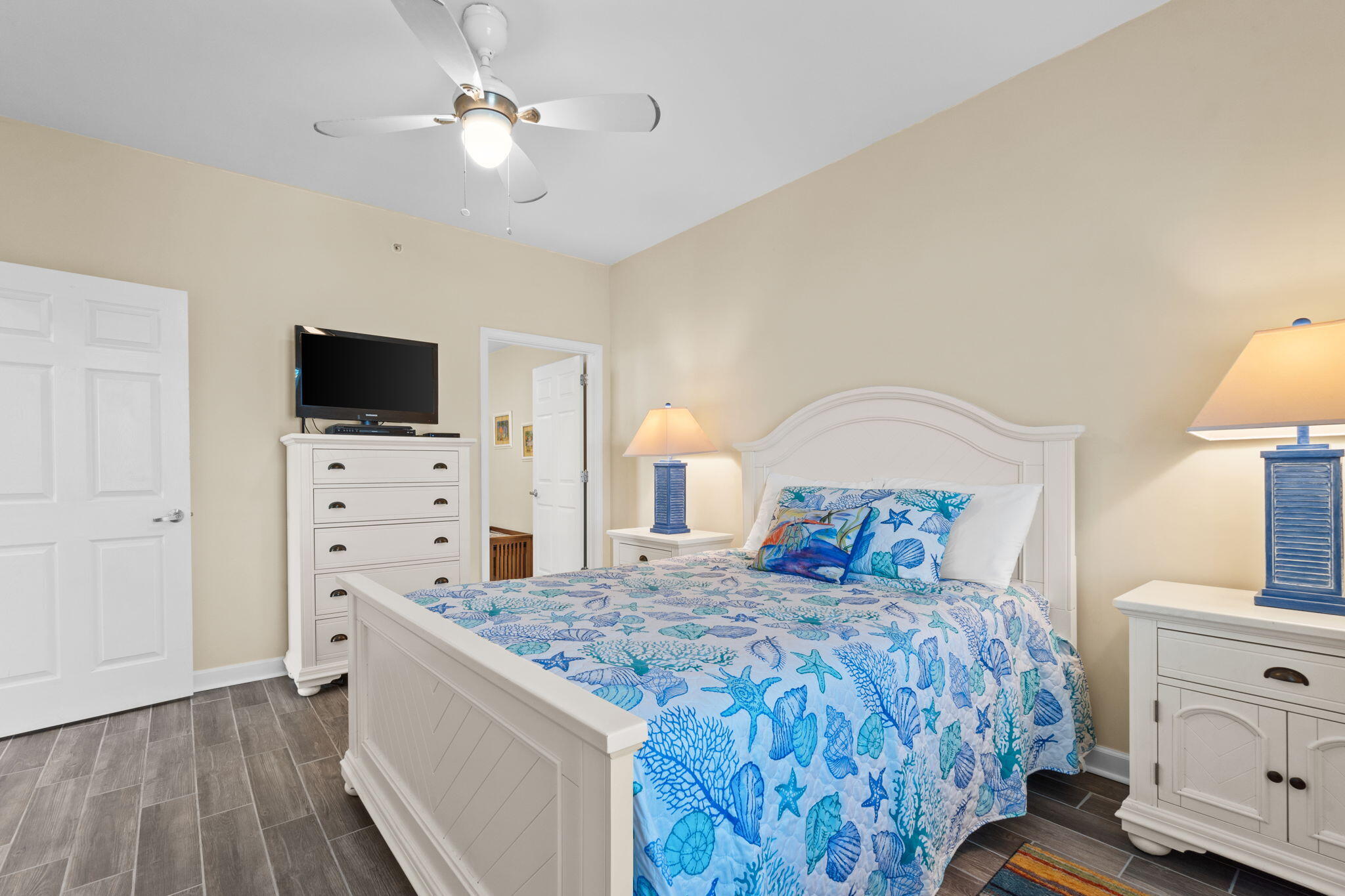 12011 Front Beach Road, Unit 201C Panama City Beach, FL 32407 - Photo 29 of 42 a bedroom with a bed and a flat screen tv