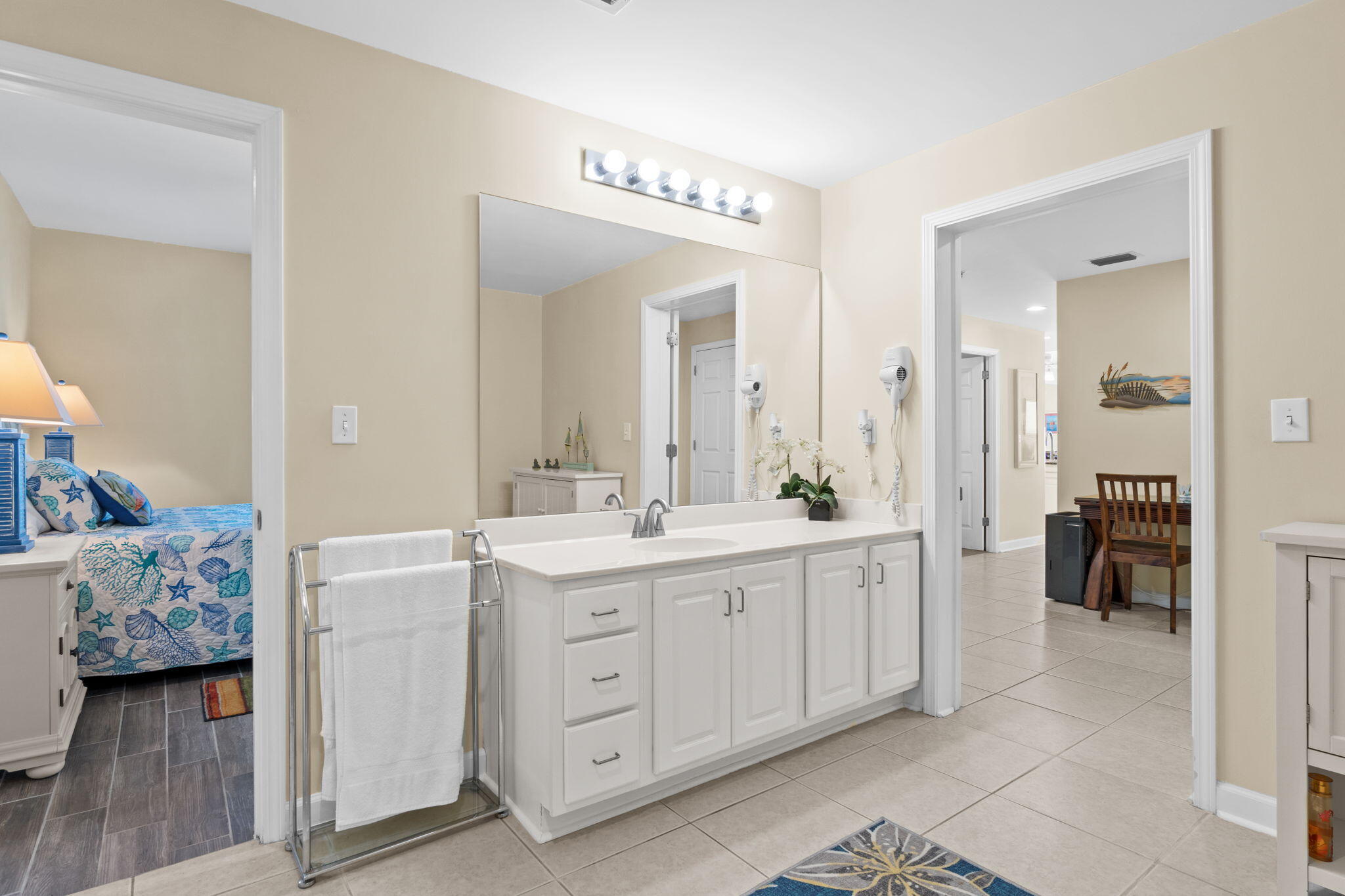 12011 Front Beach Road, Unit 201C Panama City Beach, FL 32407 - Photo 31 of 42 a spacious bathroom with a granite countertop sink and a mirror