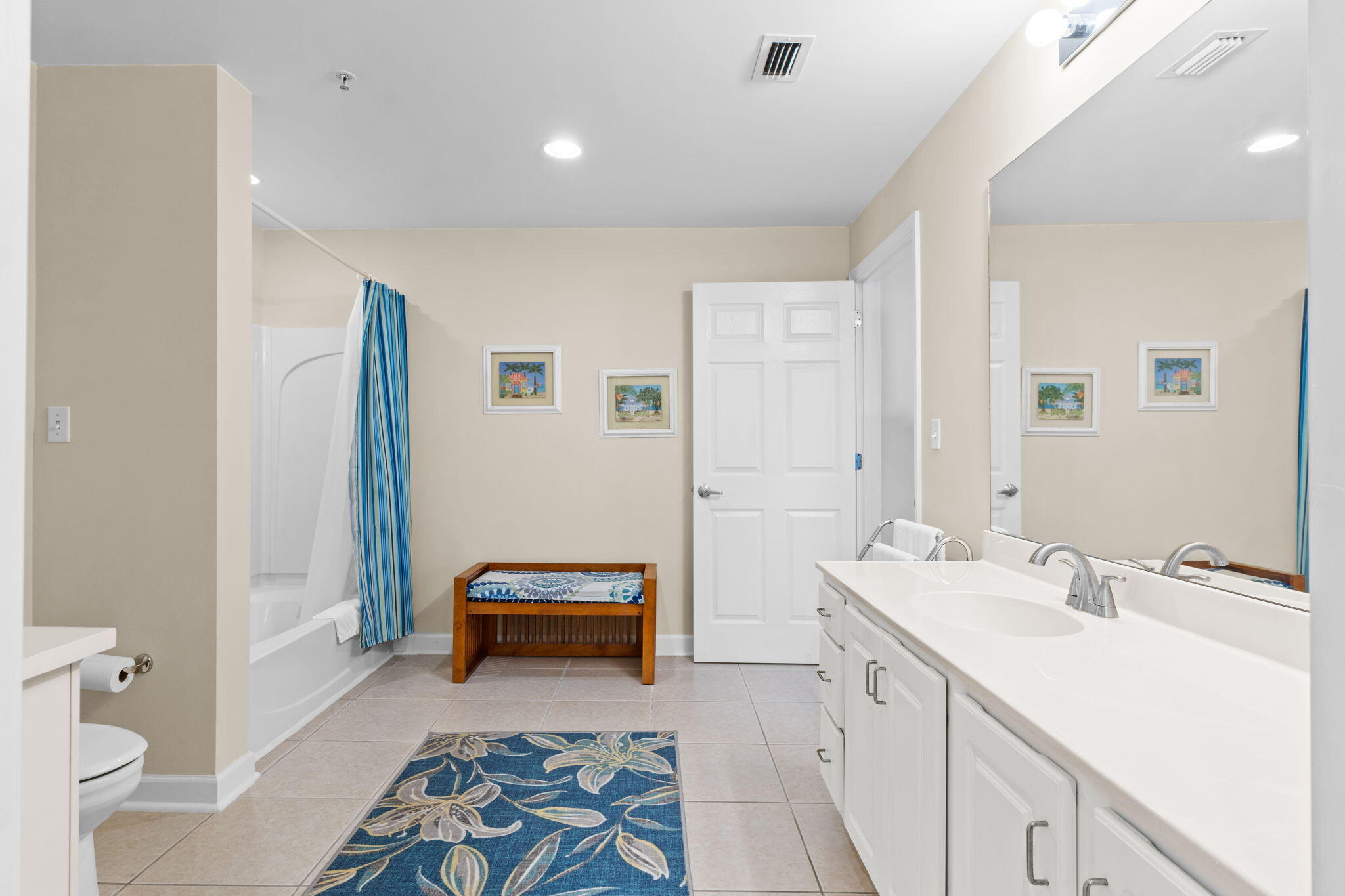 12011 Front Beach Road, Unit 201C Panama City Beach, FL 32407 - Photo 32 of 42 a spacious bathroom with a double vanity sink a mirror and a toilet