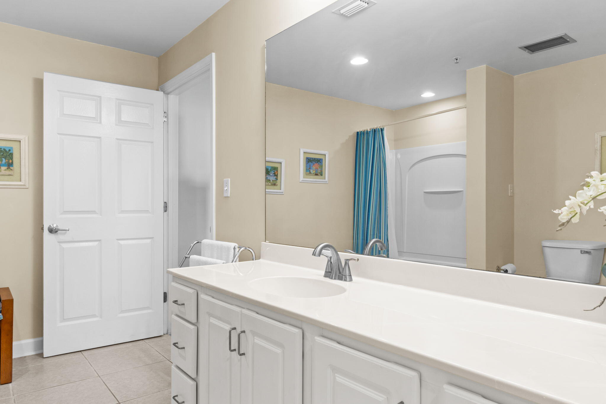 12011 Front Beach Road, Unit 201C Panama City Beach, FL 32407 - Photo 33 of 42 a bathroom with a sink and a mirror