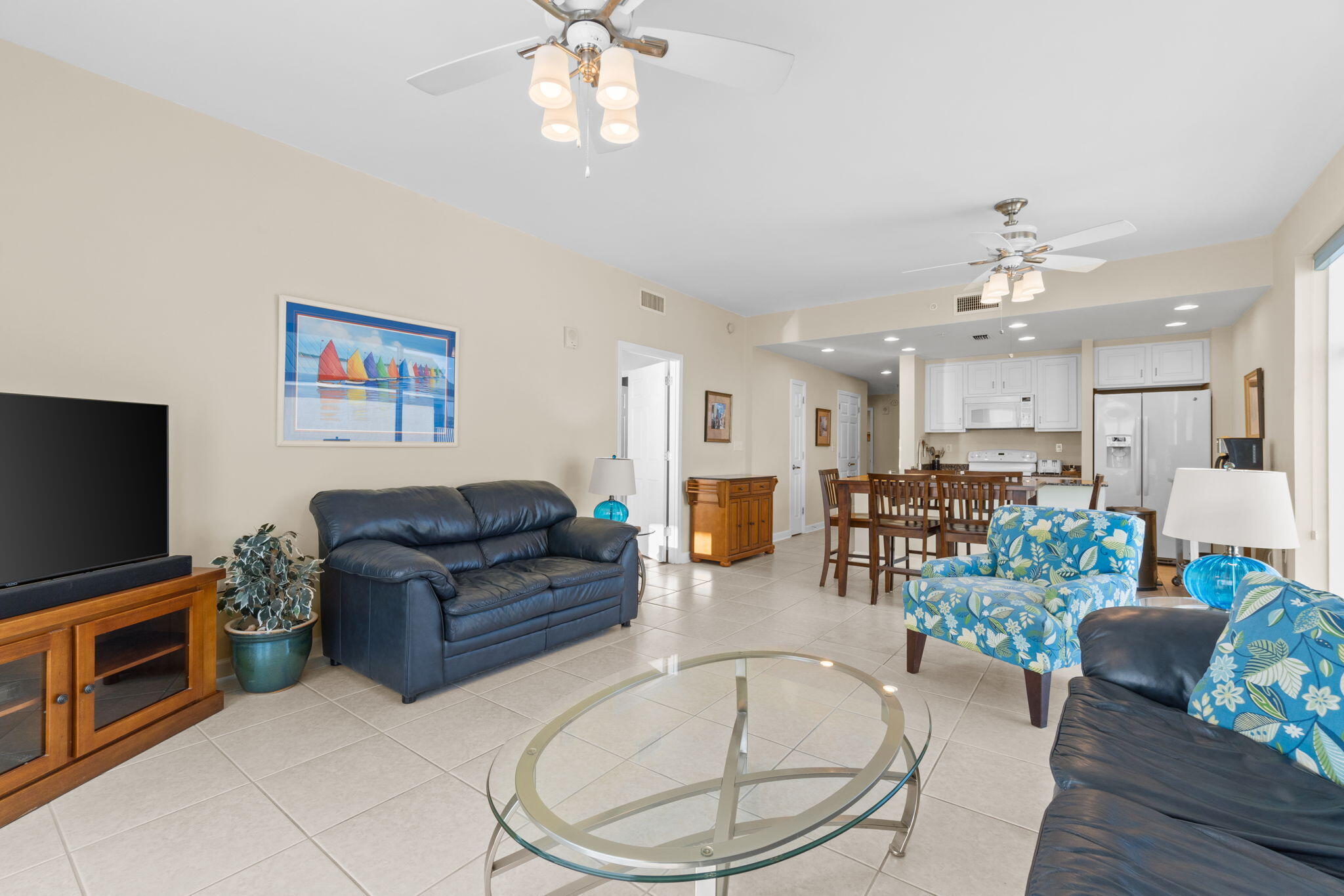 12011 Front Beach Road, Unit 201C Panama City Beach, FL 32407 - Photo 5 of 42 a living room with furniture and a flat screen tv