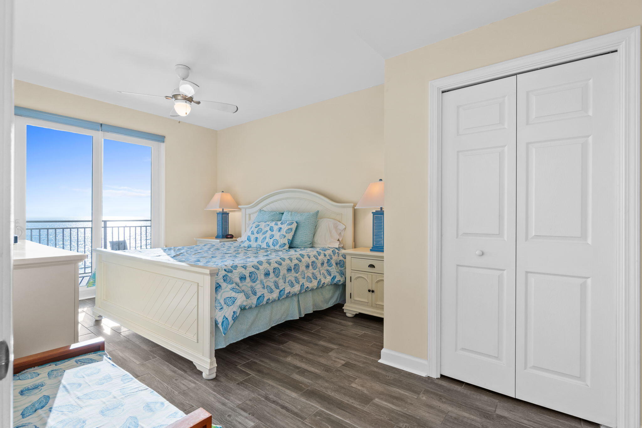 12011 Front Beach Road, Unit 201C Panama City Beach, FL 32407 - Photo 7 of 42 a bedroom with a bed and a chandelier