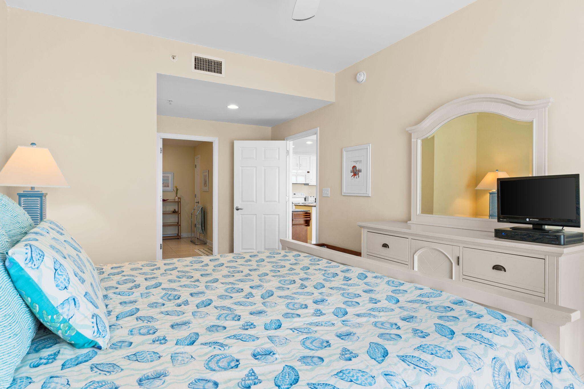 12011 Front Beach Road, Unit 201C Panama City Beach, FL 32407 - Photo 10 of 42 a bedroom with a bed and a flat screen tv