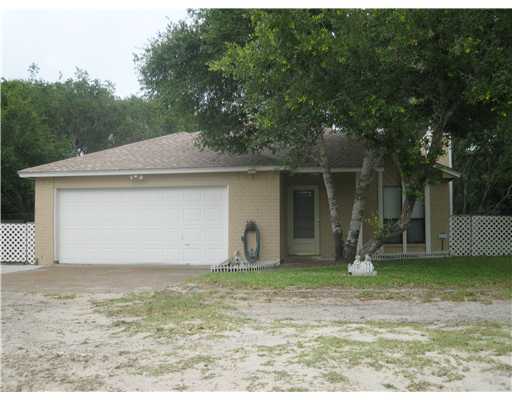 a house that has a tree in front of it
