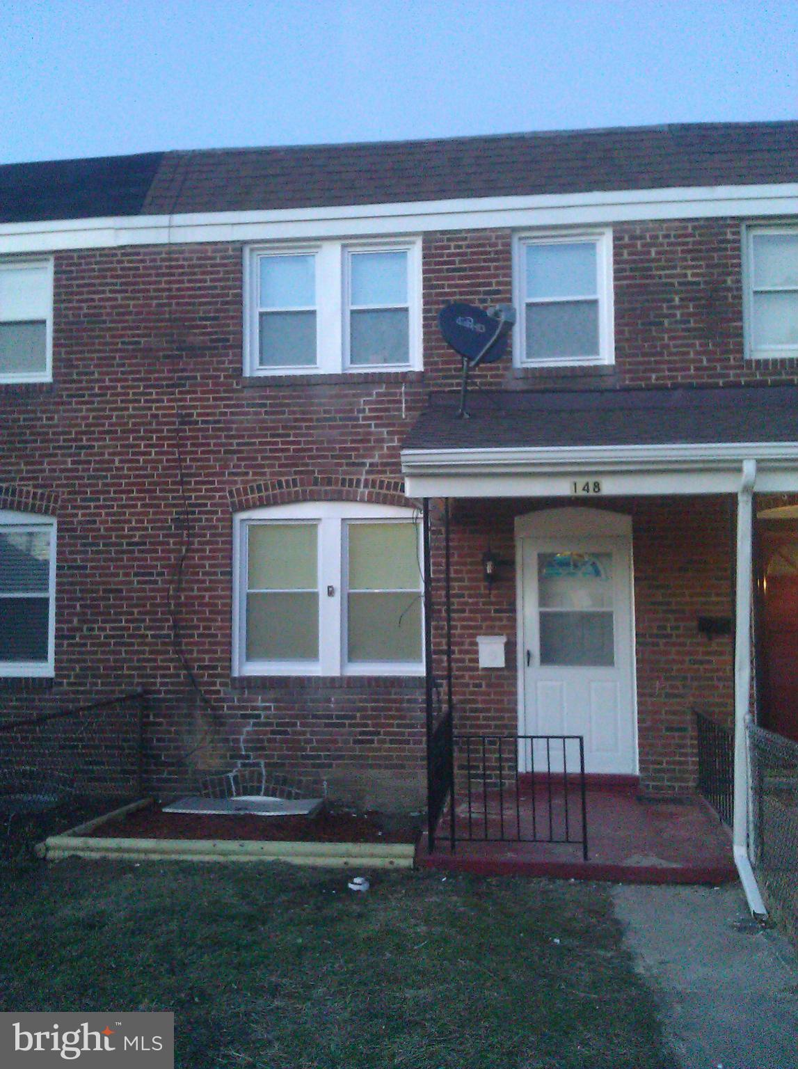 148 West Edgevale Road Baltimore, MD 21225 - Photo 1 of 12 a brick house with a yard in front of it