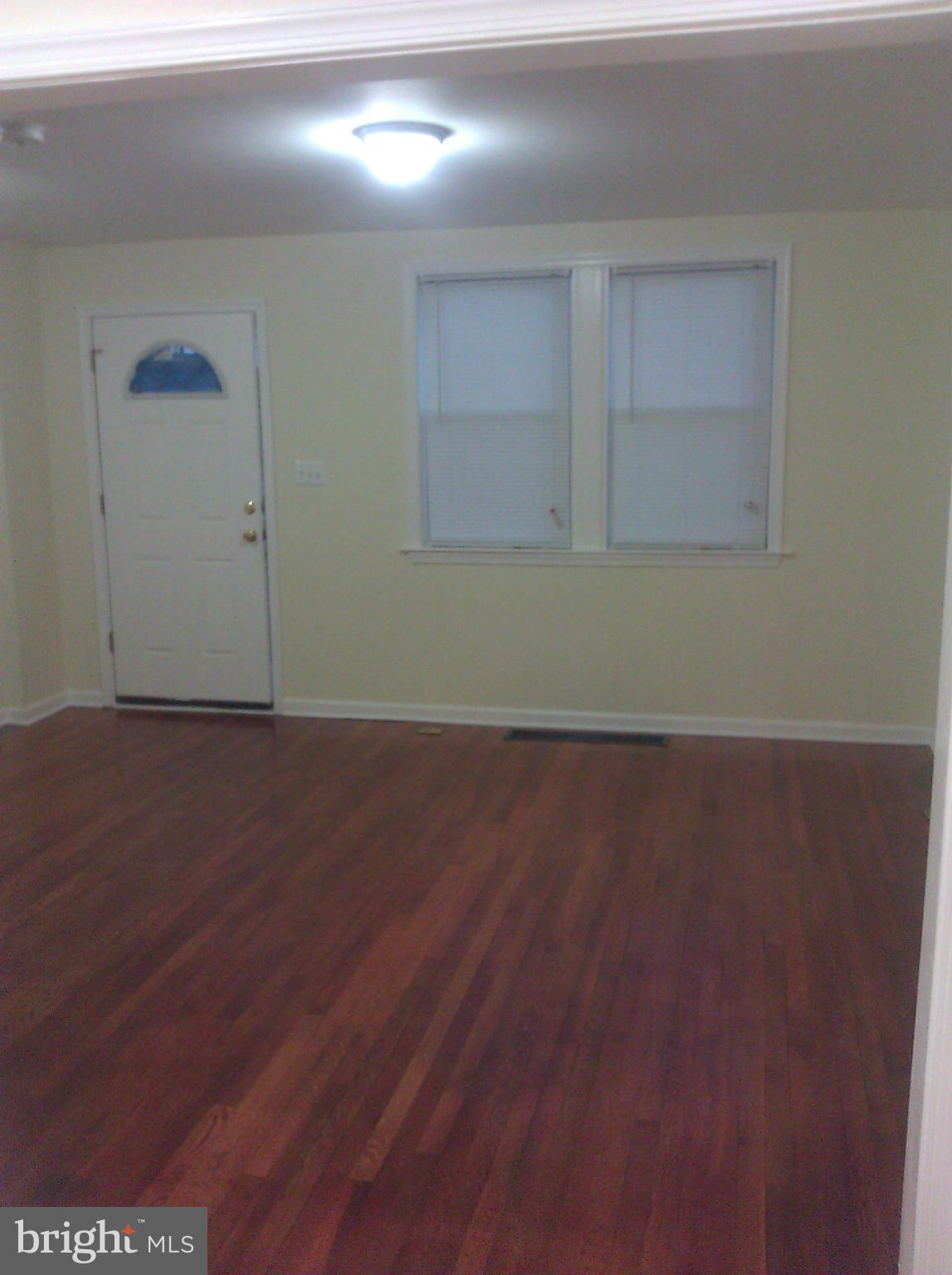 148 West Edgevale Road Baltimore, MD 21225 - Photo 2 of 12 an empty room with wooden floor