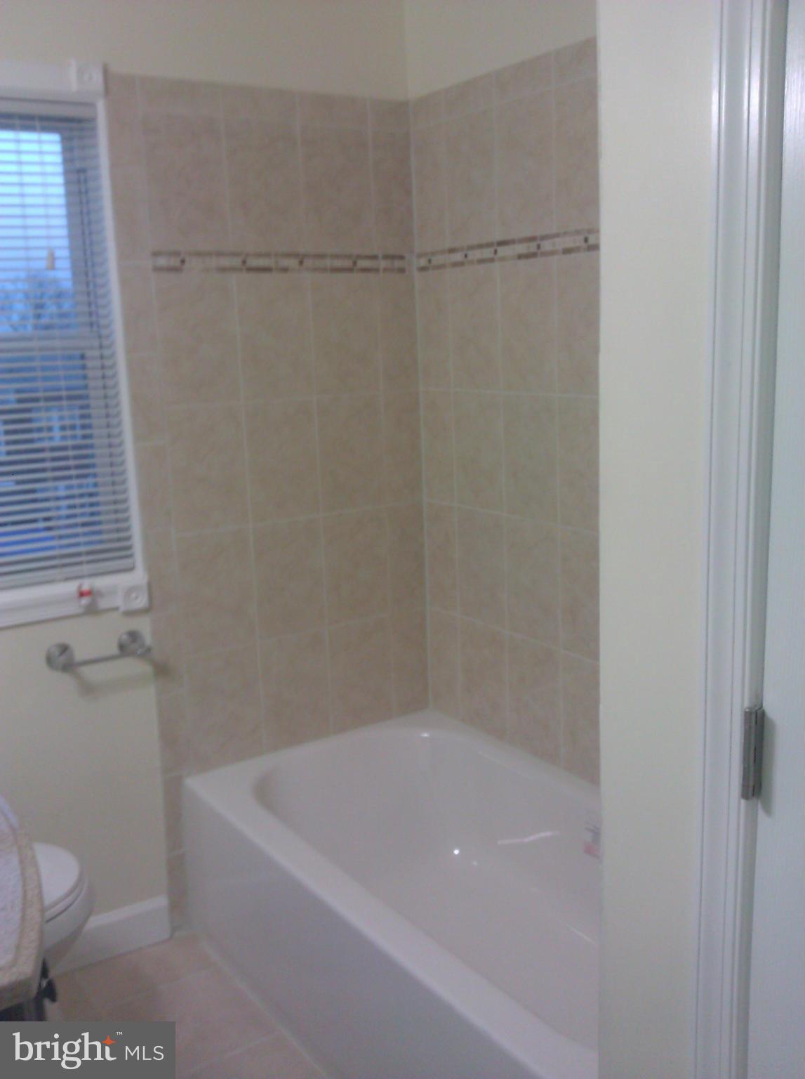 148 West Edgevale Road Baltimore, MD 21225 - Photo 11 of 12 a bath room with a toilet and a bath tub